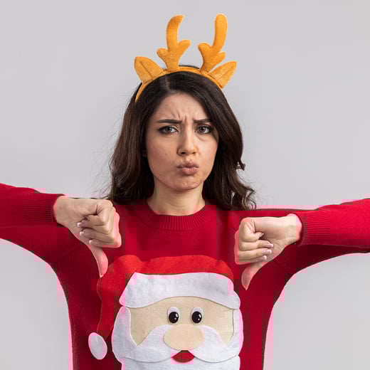 frowning-young-pretty-girl-wearing-reindeer-antlers-headband-santa-claus-sweater-showing-thumbs-down-isolated-white-wall