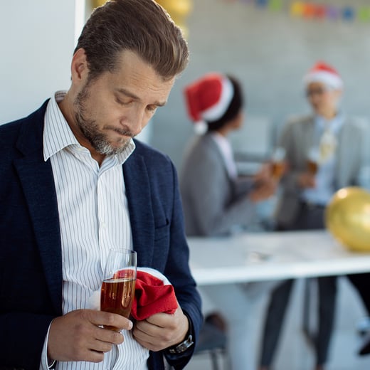 mid-adult-businessman-feeling-sad-while-being-christmas-party-office